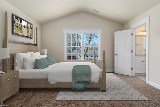 bedroom with vaulted ceiling, baseboards, visible vents, ensuite bath, and carpet floors