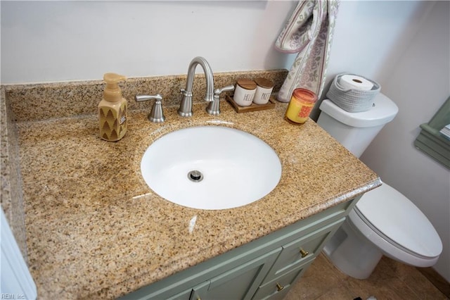 bathroom featuring toilet, vanity, and tile patterned floors