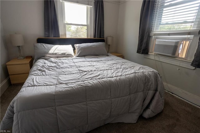 carpeted bedroom featuring baseboards, crown molding, and multiple windows