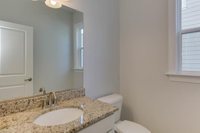 bathroom with toilet and vanity