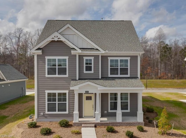 craftsman inspired home featuring board and batten siding, a shingled roof, and covered porch