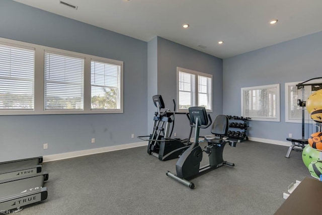 exercise area with visible vents, baseboards, and recessed lighting