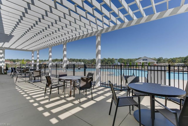 view of patio / terrace with a community pool, a pergola, outdoor dining area, and fence