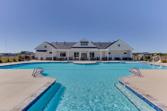 pool featuring a patio area and fence