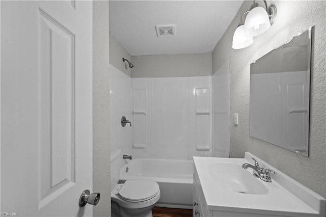 bathroom featuring  shower combination, toilet, visible vents, a textured wall, and vanity