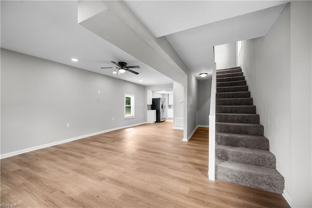 stairway with wood finished floors, a ceiling fan, baseboards, and recessed lighting