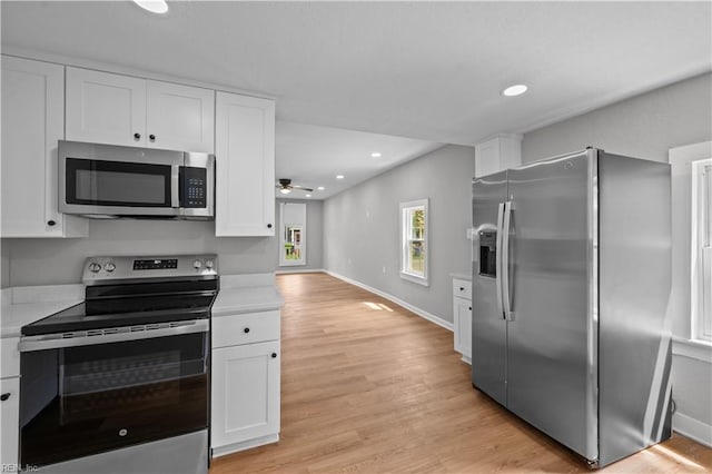 kitchen with white cabinets, appliances with stainless steel finishes, and light countertops