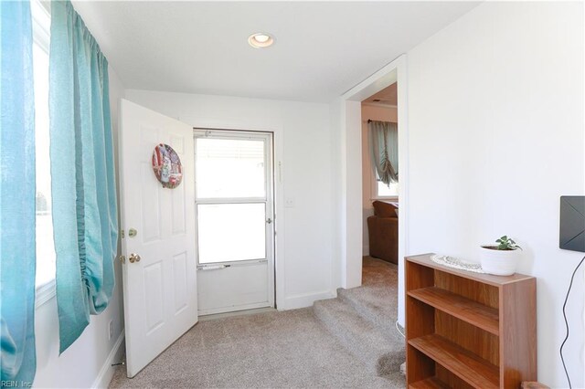 carpeted foyer entrance featuring baseboards and recessed lighting
