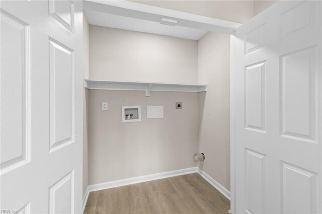 clothes washing area with wood finished floors, hookup for a washing machine, baseboards, and electric dryer hookup
