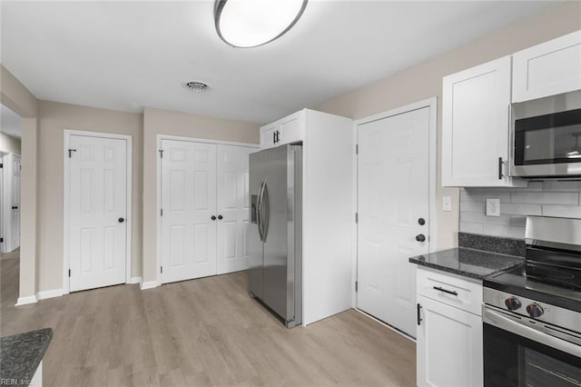kitchen featuring light wood-type flooring, visible vents, white cabinets, and appliances with stainless steel finishes