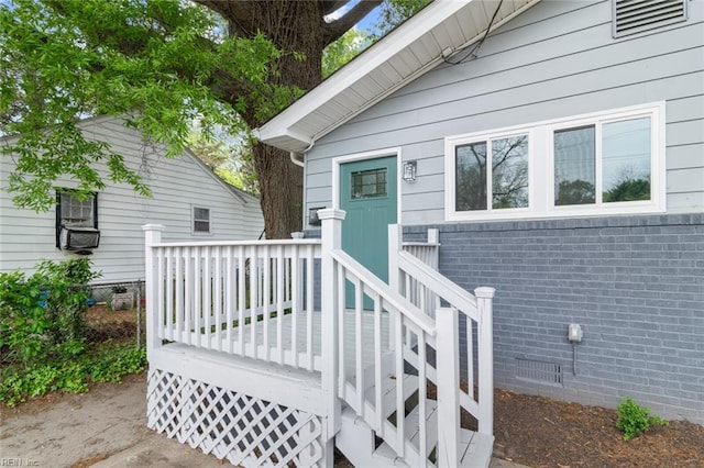 property entrance with a wooden deck and crawl space