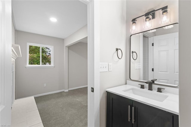 bathroom with baseboards and vanity