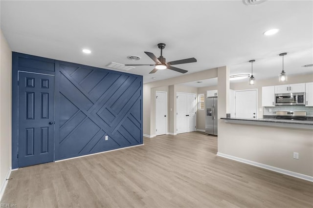 unfurnished living room with light wood-style flooring, visible vents, baseboards, and ceiling fan