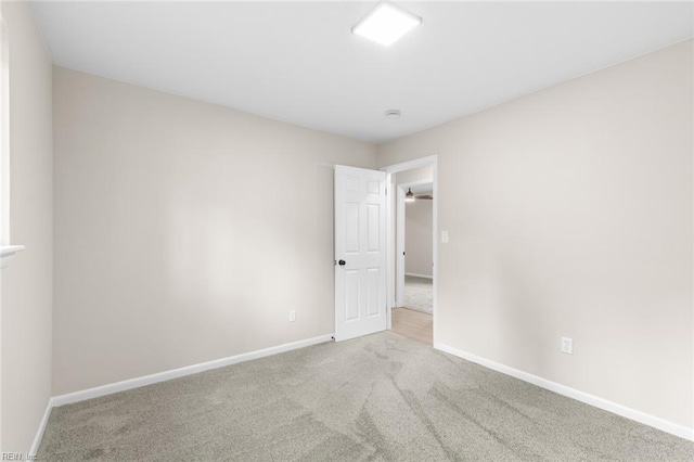 unfurnished room with baseboards and carpet floors