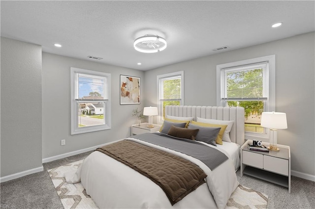 carpeted bedroom with recessed lighting, visible vents, and baseboards