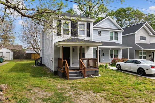 view of front of house featuring a porch, an outdoor structure, a storage shed, and a front yard