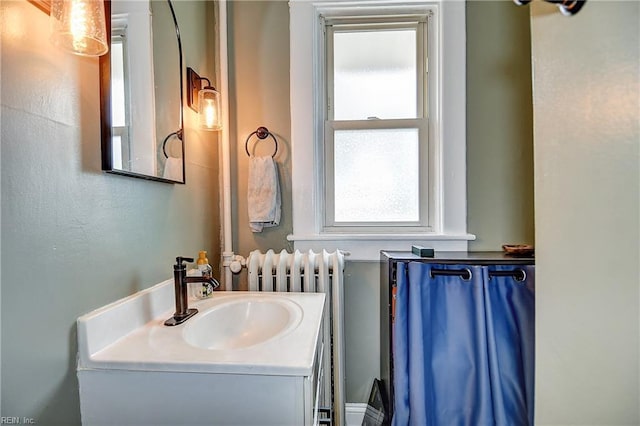 bathroom featuring radiator and vanity