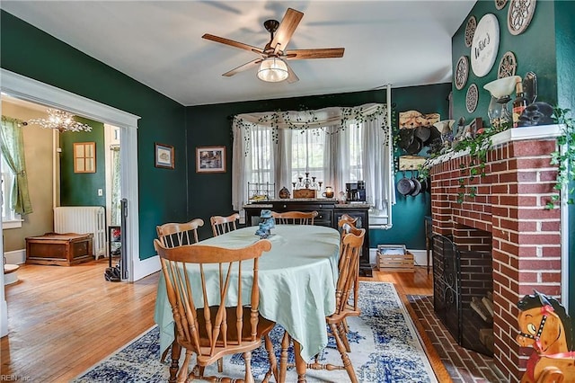 dining space with plenty of natural light, a ceiling fan, baseboards, and wood finished floors