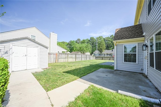 view of yard with a fenced backyard, a storage unit, an outbuilding, and a patio