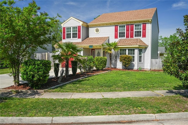 traditional home featuring a front lawn and fence