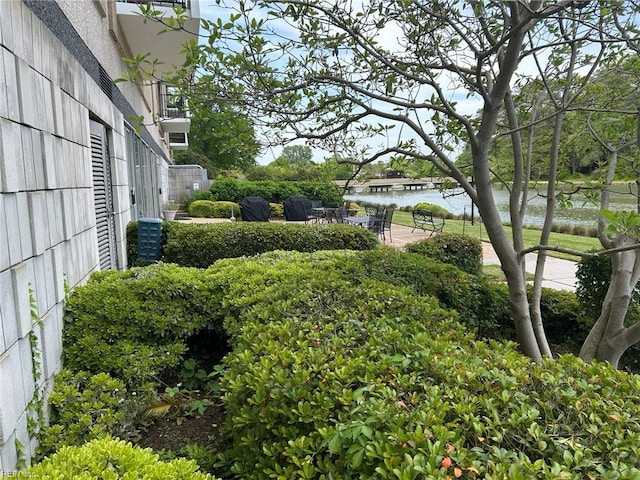 view of yard featuring a water view and a patio area
