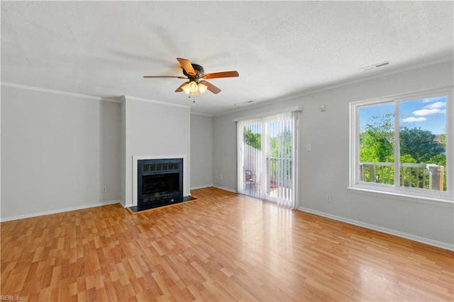 unfurnished living room with plenty of natural light, light wood-style flooring, and visible vents