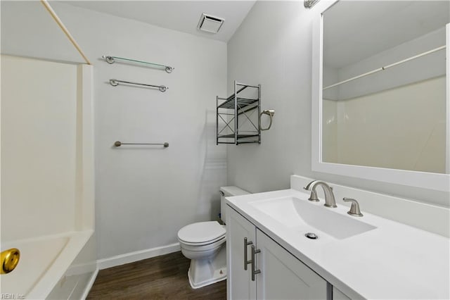 full bath featuring wood finished floors, vanity, baseboards, toilet, and visible vents