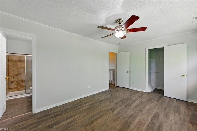 unfurnished bedroom with wood finished floors, visible vents, a closet, baseboards, and ceiling fan
