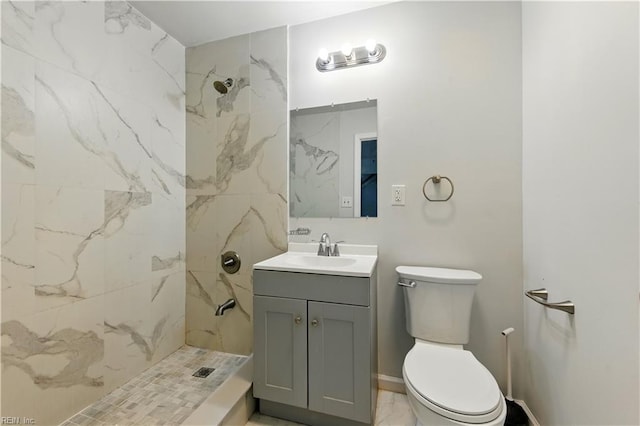 bathroom with toilet, vanity, and a marble finish shower