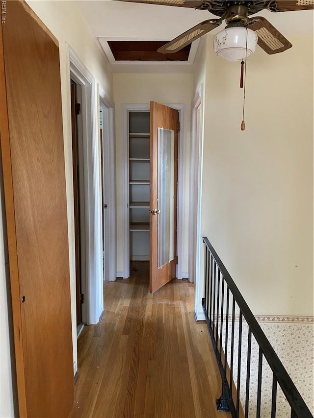 hallway featuring wood finished floors and an upstairs landing