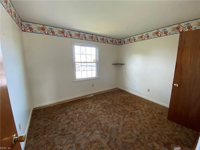 carpeted empty room with visible vents and baseboards