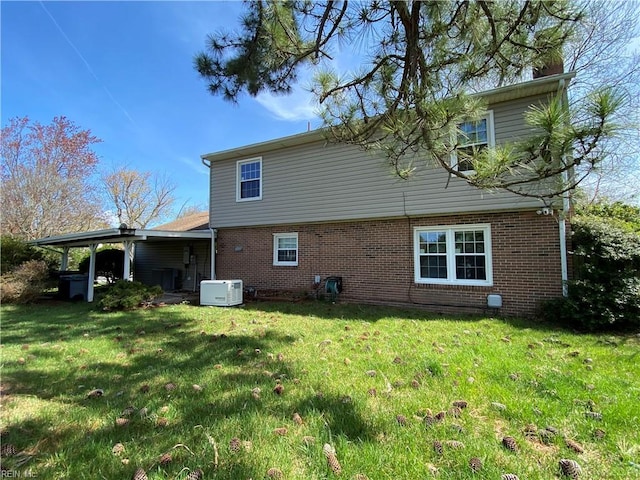 rear view of house with brick siding and a yard