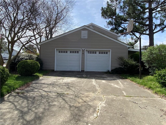 garage featuring concrete driveway