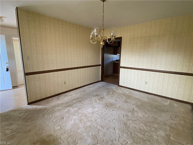 unfurnished dining area featuring an inviting chandelier, wallpapered walls, and carpet