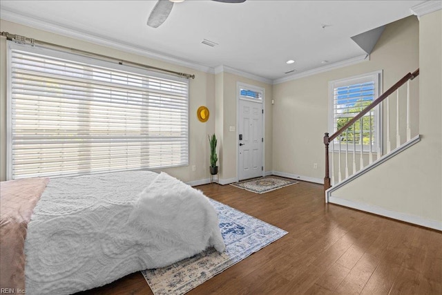bedroom with ornamental molding, recessed lighting, wood finished floors, and baseboards