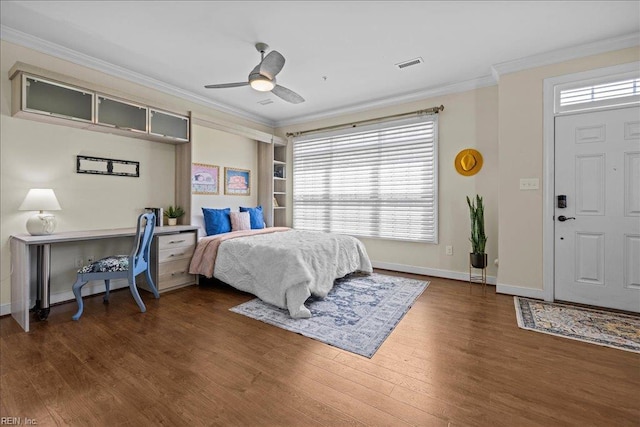 bedroom featuring ornamental molding, visible vents, multiple windows, and wood finished floors