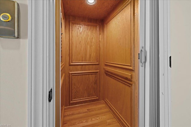 details with recessed lighting, wood finished floors, and elevator