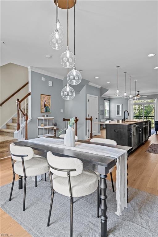 dining space with stairway, ornamental molding, recessed lighting, and light wood-style flooring