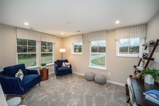 sitting room with recessed lighting, baseboards, a healthy amount of sunlight, and carpet