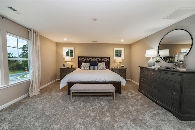bedroom featuring carpet floors, visible vents, and baseboards