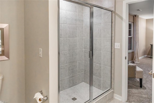bathroom featuring visible vents, toilet, baseboards, and a stall shower