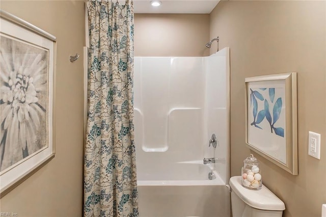 bathroom with toilet and shower / tub combo with curtain