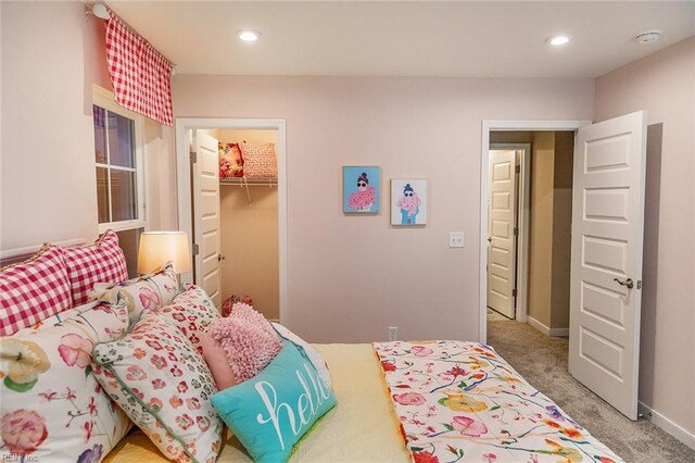 bedroom with baseboards, a spacious closet, recessed lighting, a closet, and carpet floors