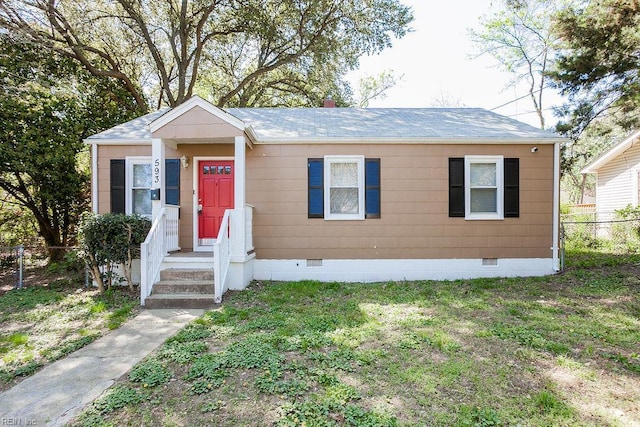 view of front of home with roof with shingles, crawl space, a front lawn, and fence