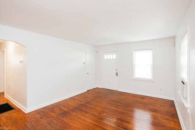 interior space with baseboards, hardwood / wood-style floors, and visible vents