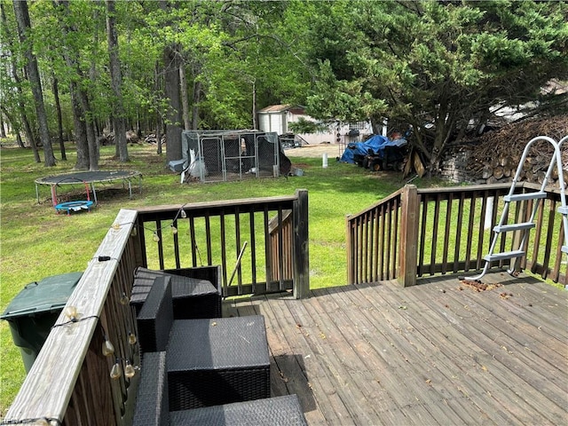2310 S St S, Franklin, VA 23851 - wooden deck featuring a yard, a trampoline, and an outbuilding
