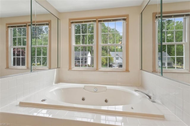 full bathroom featuring plenty of natural light and a whirlpool tub