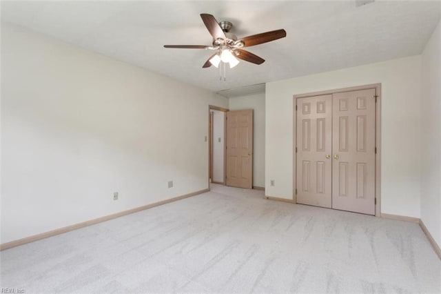 unfurnished bedroom with light carpet, a ceiling fan, baseboards, and a closet
