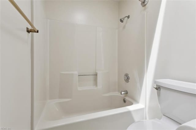 bathroom with toilet and shower / bath combination