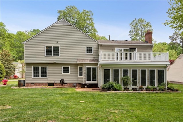 rear view of property with a lawn, a balcony, crawl space, and central AC unit